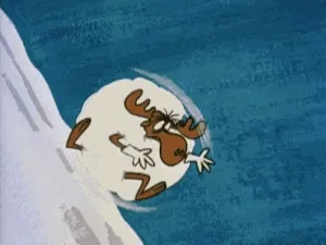 Un reno dentro de una bola de nieve bajando una colina.